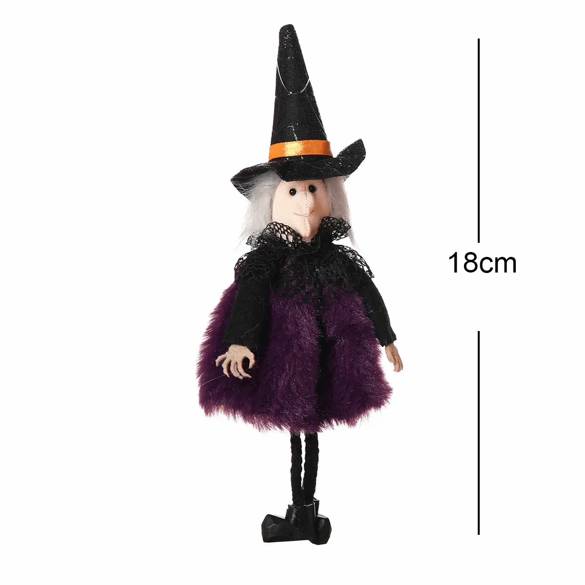 a doll wearing a witches costume and a hat