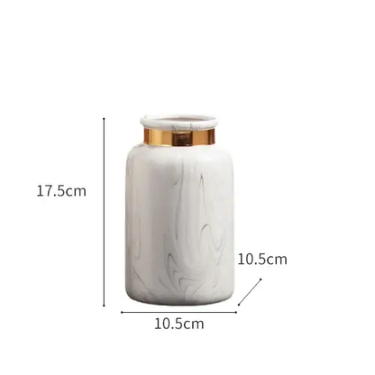 a white marble jar with a gold lid
