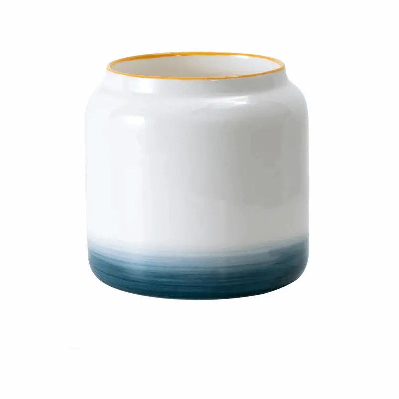 a white and blue vase sitting on top of a table