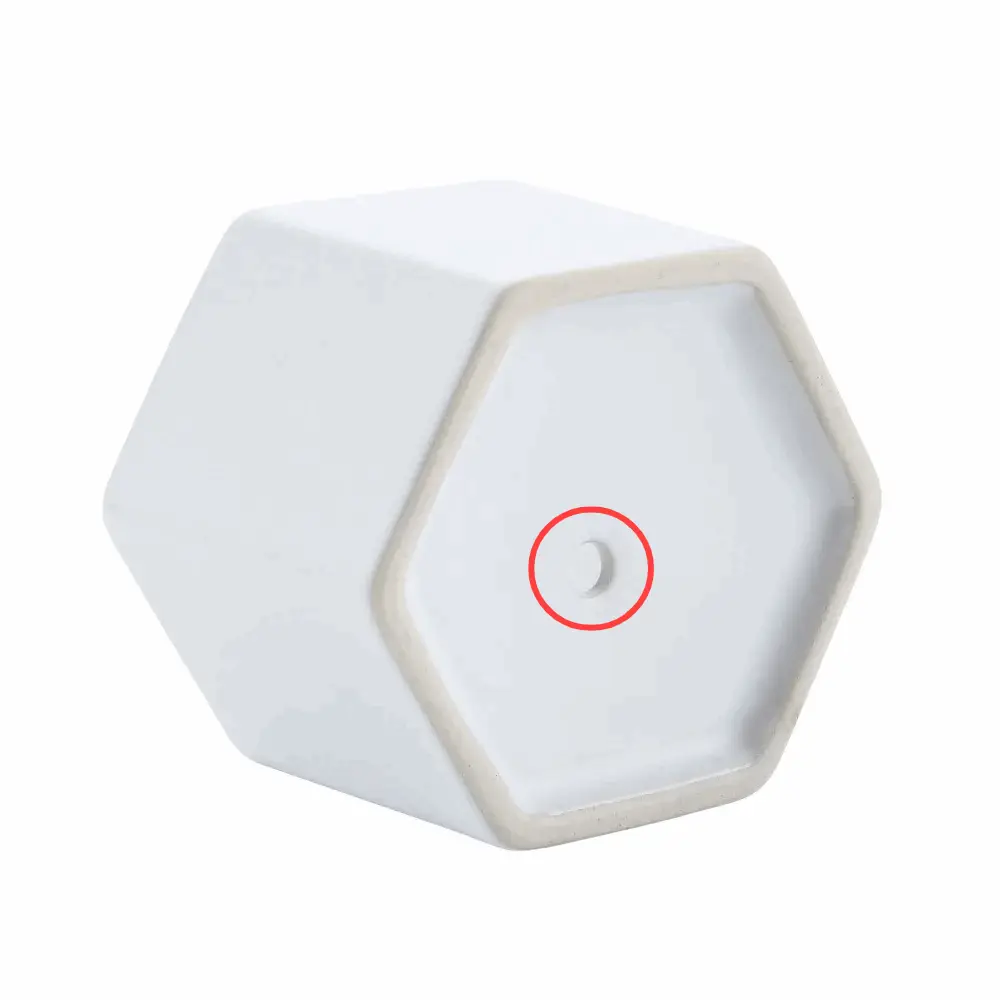 a white hexagonal object with a red circle on it