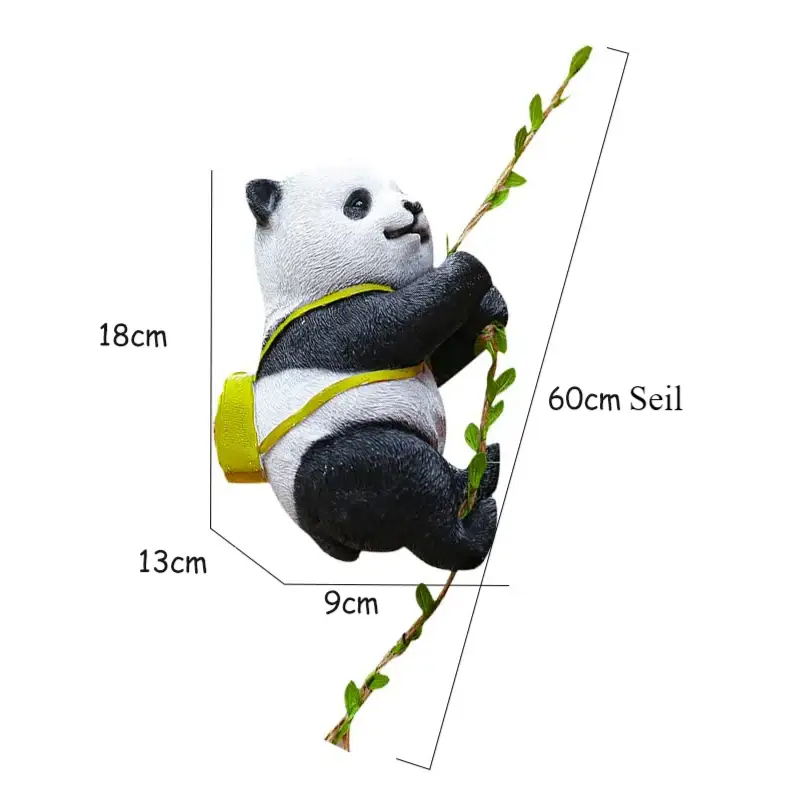 a stuffed panda bear hanging on a tree branch
