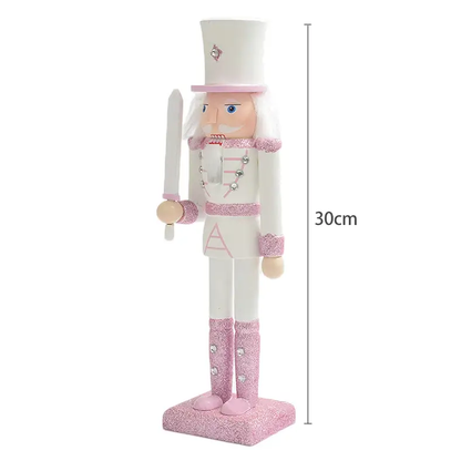a pink and white wooden nutcracker figure