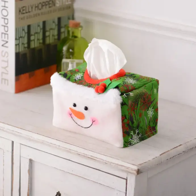 a snowman tissue box sitting on top of a white dresser