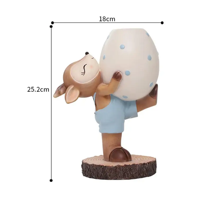 a small figurine of a person holding a large egg
