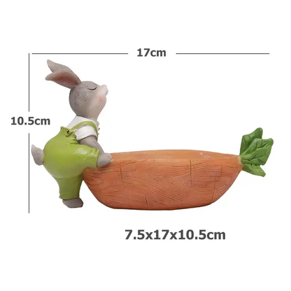 a toy rabbit riding on top of a carrot
