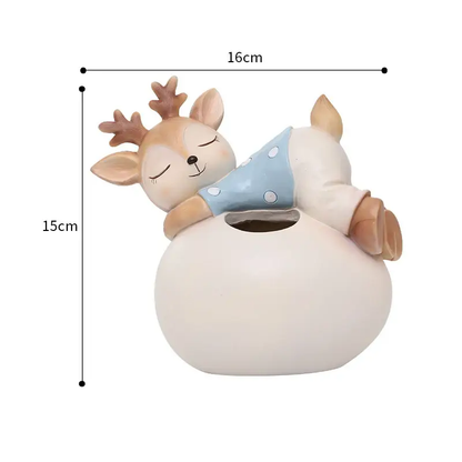 a ceramic deer sleeping on top of a white vase