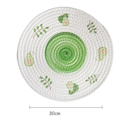 a green and white plate with leaves on it