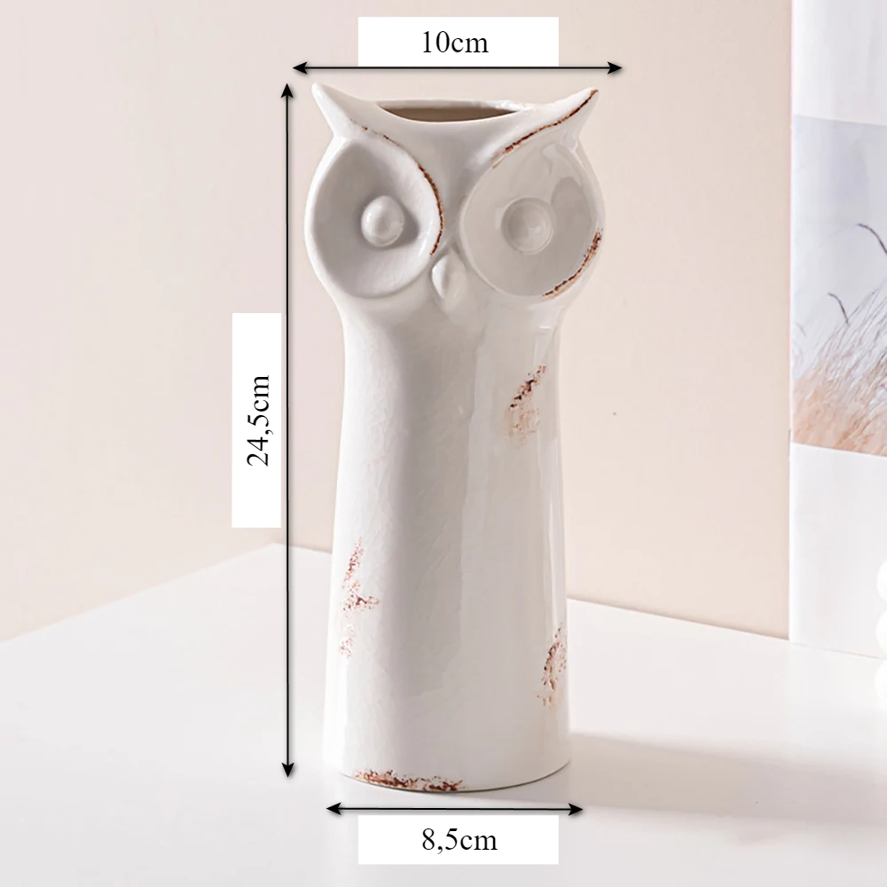 a white vase with an owl design on it