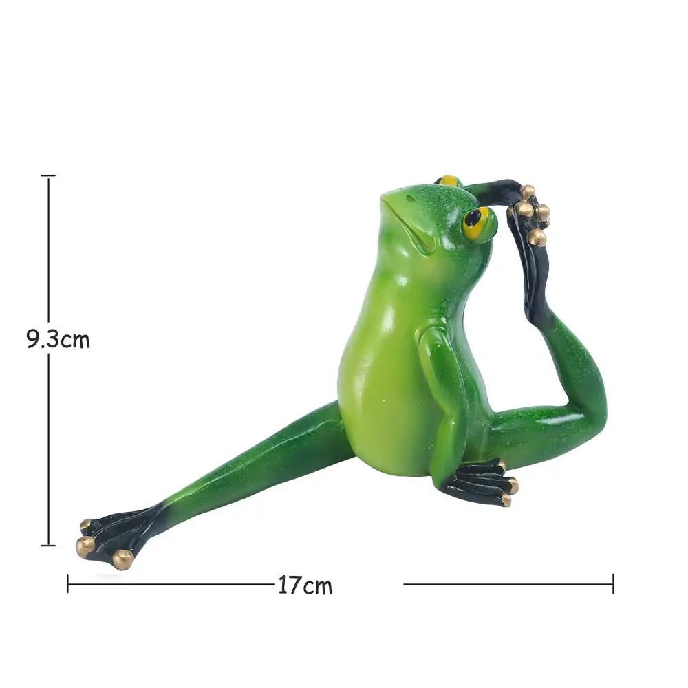 a green frog figurine sitting on a white background