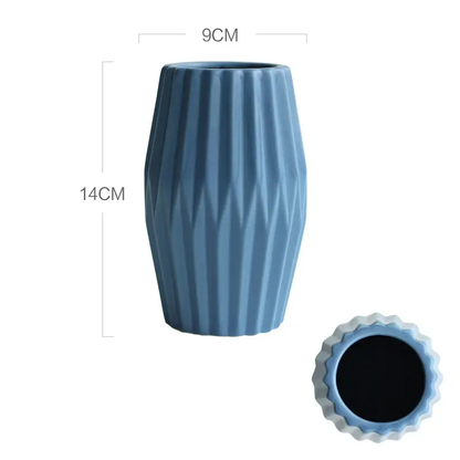 a blue vase sitting next to a black hole