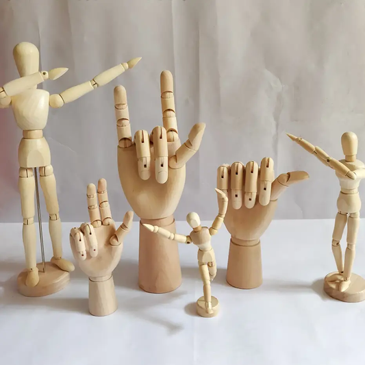 a group of wooden hand puppets are posed together