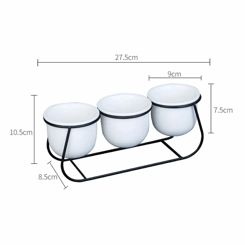 three white bowls on a metal stand with measurements