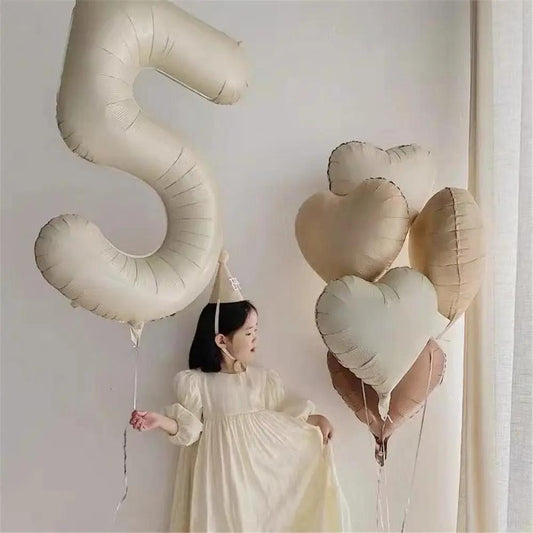 a woman standing in front of a number five balloon