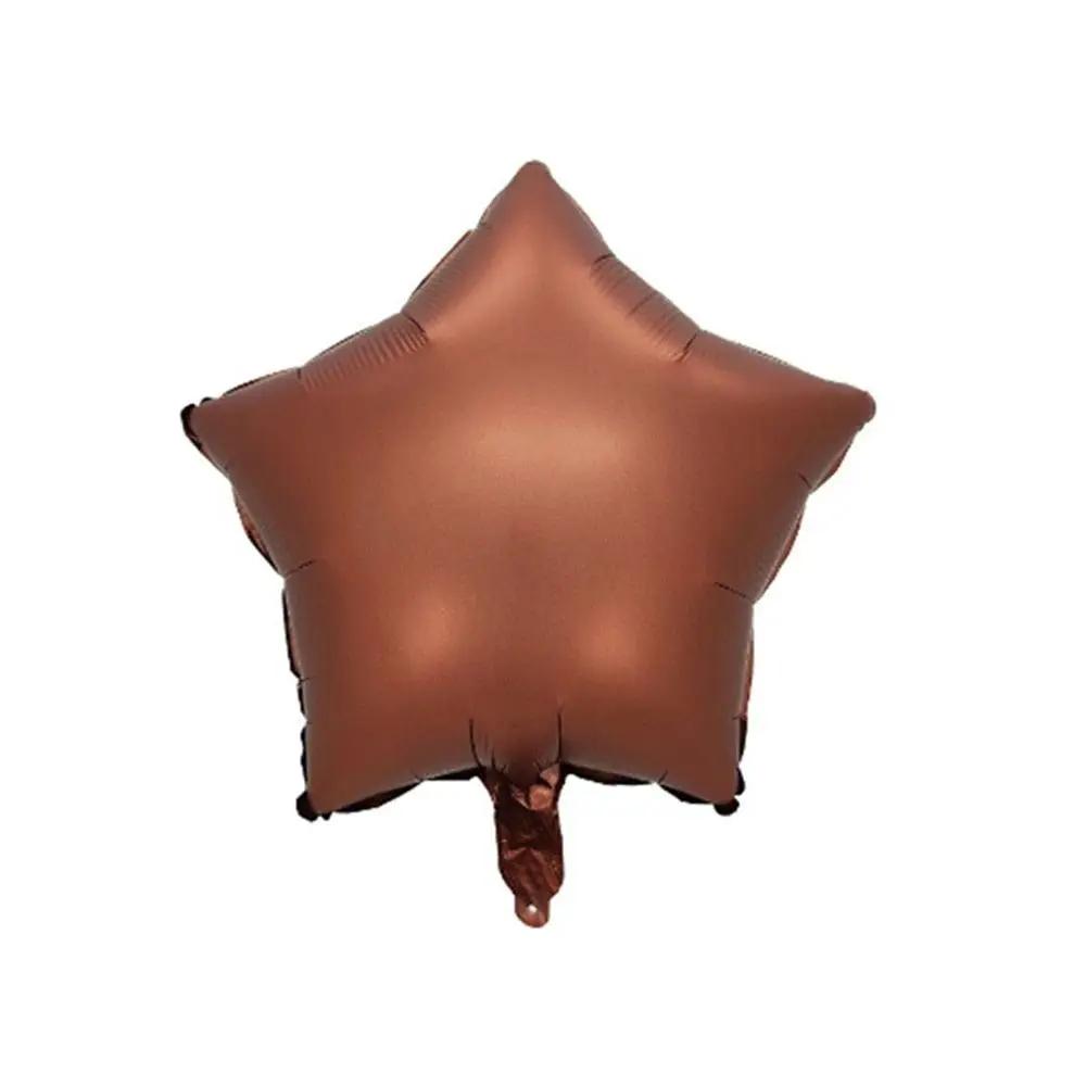 a brown star shaped balloon on a white background