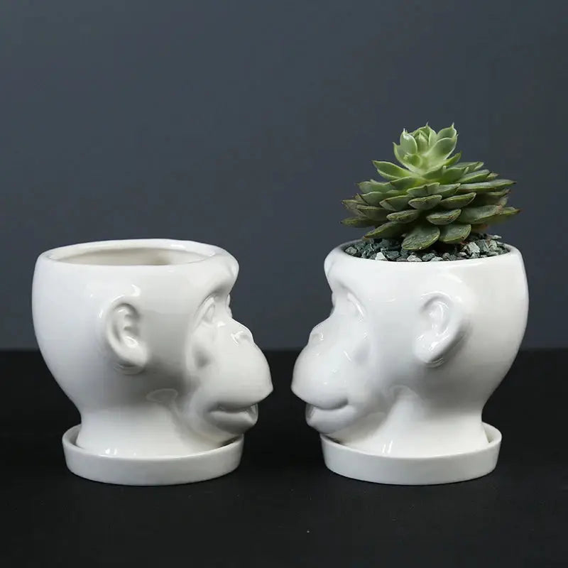 a couple of white vases sitting next to each other