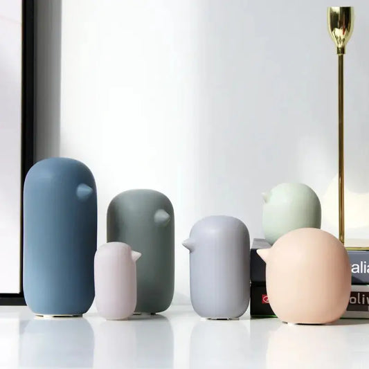 a group of different colored vases sitting next to each other