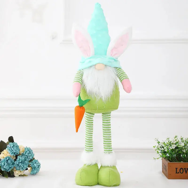 a green stuffed animal with a carrot in it's hand