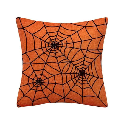 a spider web pillow on an orange background