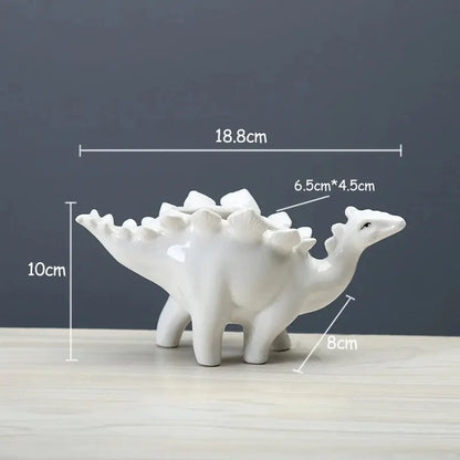 a white ceramic dinosaur planter sitting on a table