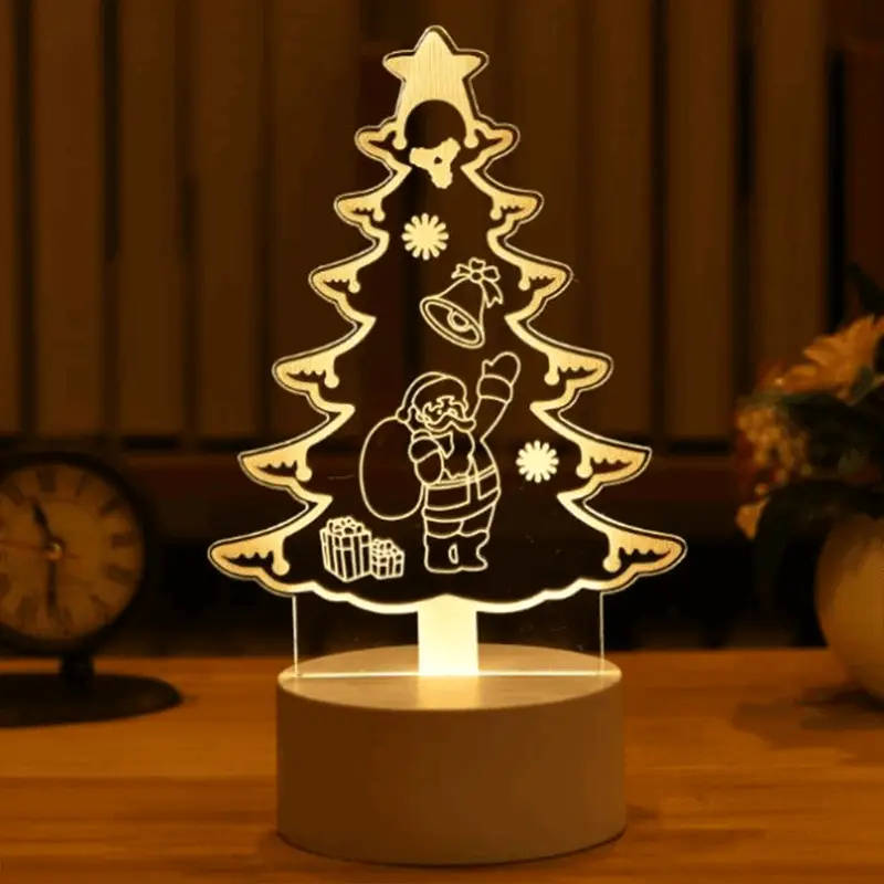 a lighted christmas tree on a table with a clock in the background