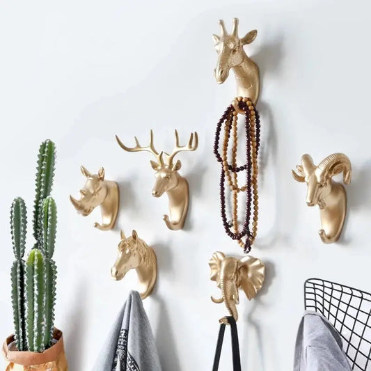 a bunch of deer head hooks on a wall
