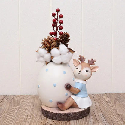 a ceramic figurine of a deer holding a cotton ball
