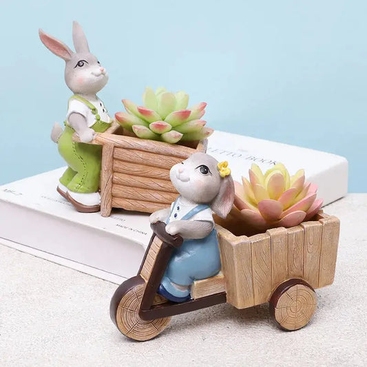 a couple of rabbits riding on top of a wooden cart