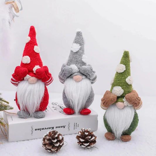 a group of three gnomes sitting next to a pine cone