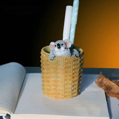 a koala in a basket with two candles sticking out of it