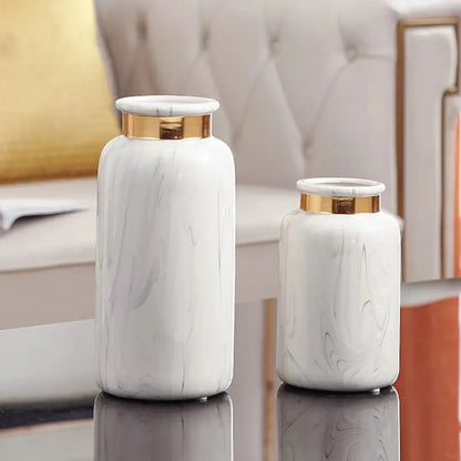two white vases sitting on top of a table