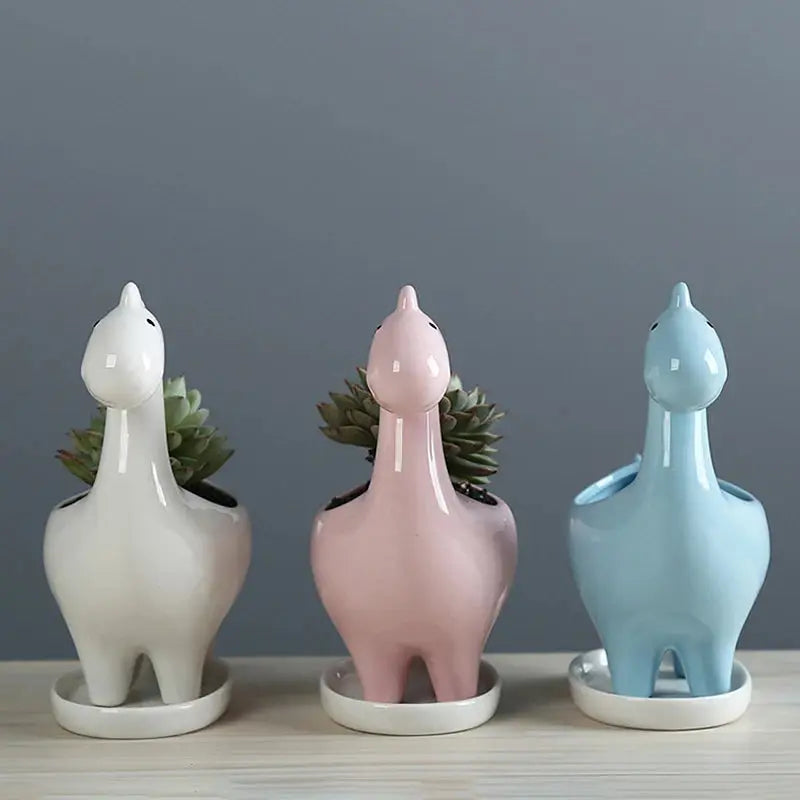 a group of three ceramic animals sitting next to each other