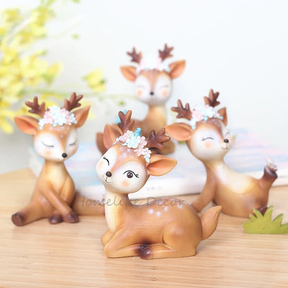 a group of deer figurines sitting on top of a wooden table