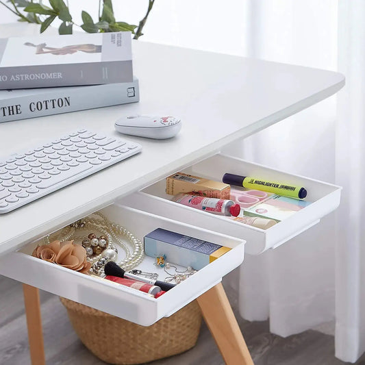a computer desk with a keyboard and two drawers