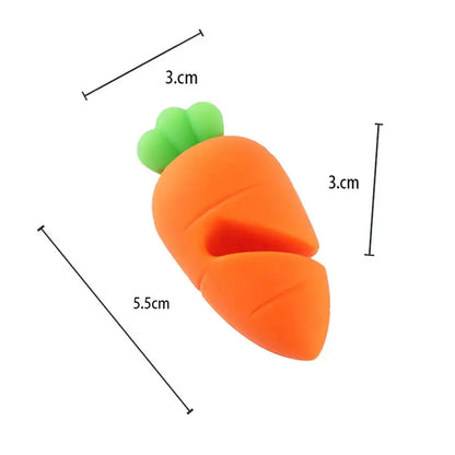 a carrot shaped eraser sitting on top of a white surface