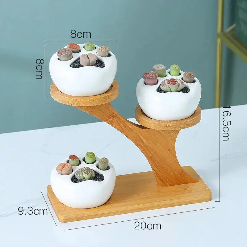a couple of white bowls sitting on top of a wooden stand