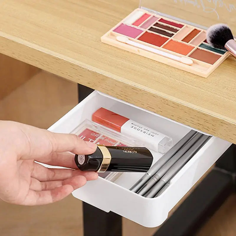 a person holding a bottle of lipstick in a drawer