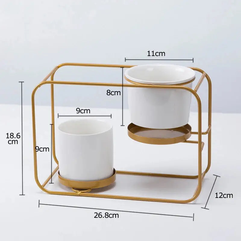 a gold and white cup holder with two cups on it