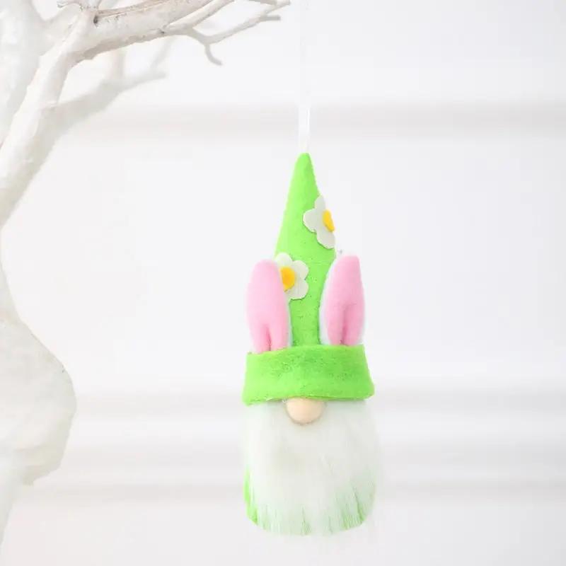 a green and white gnome ornament hanging from a tree