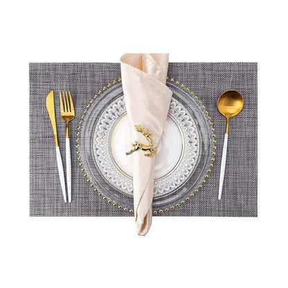 a place setting with a napkin, fork, and spoon