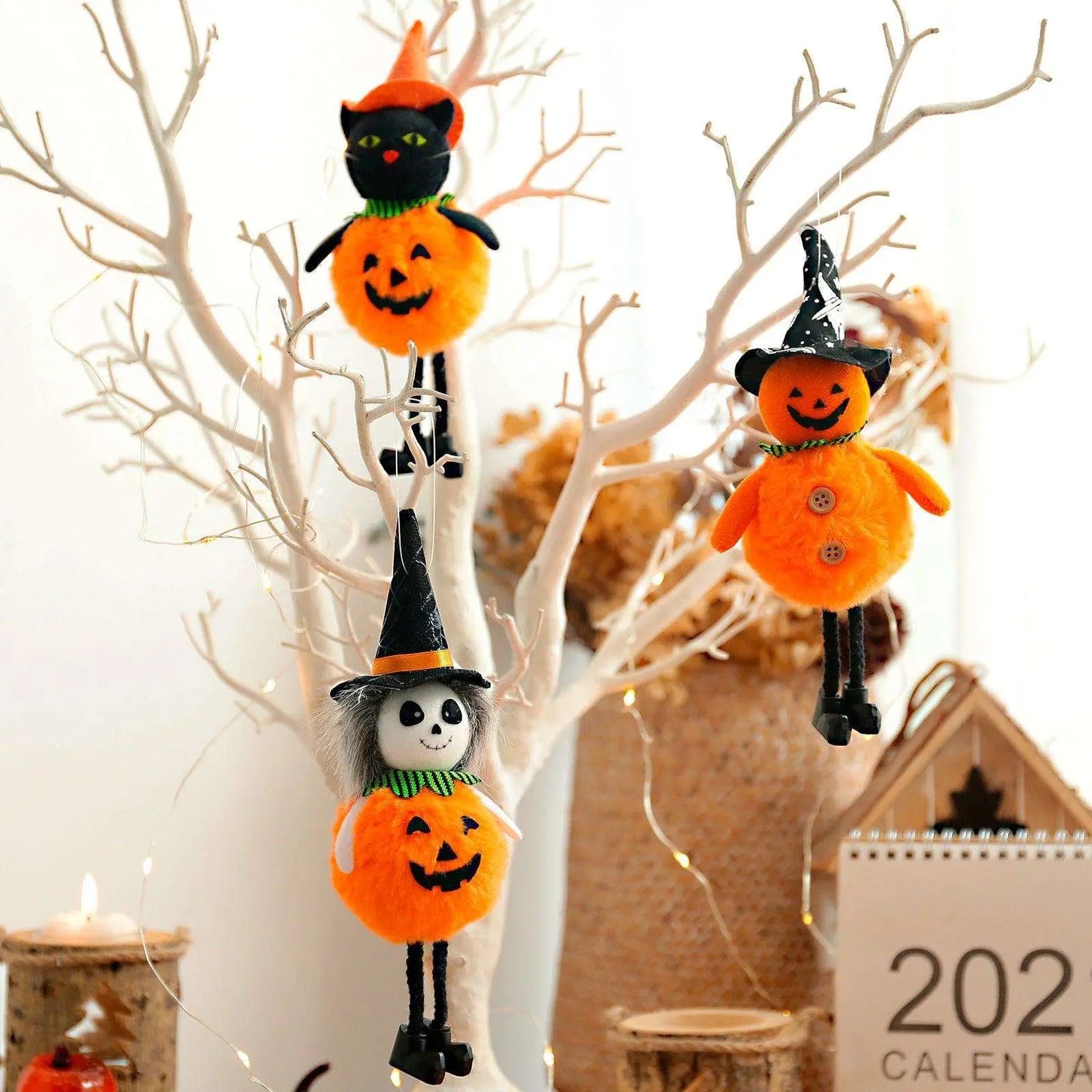a group of halloween decorations hanging from a tree