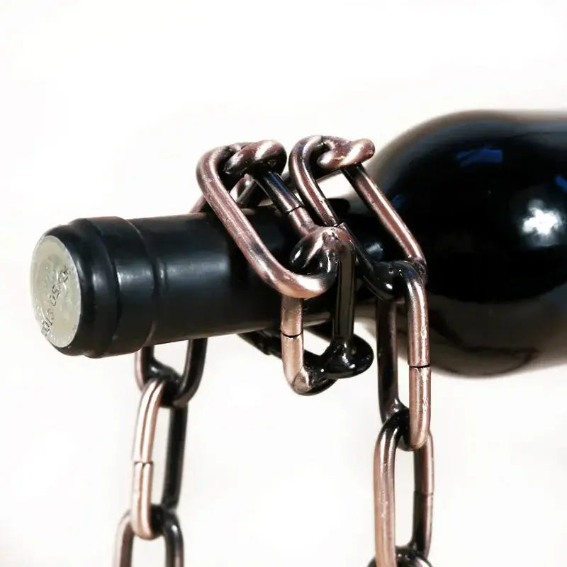a bottle of wine is chained to a metal chain