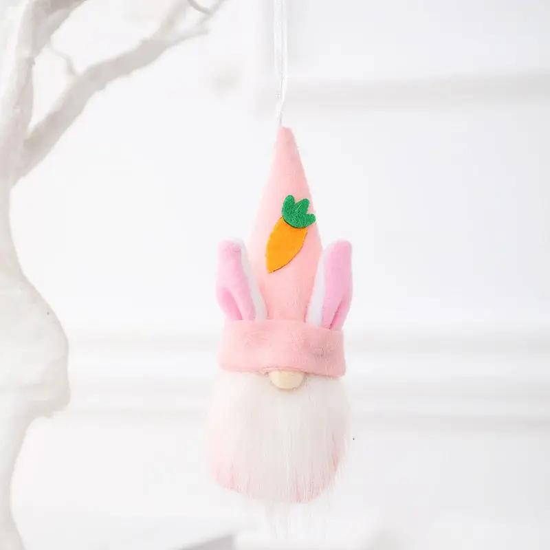 a pink gnome ornament hanging from a tree