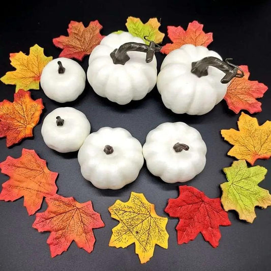 a group of white pumpkins sitting on top of a table