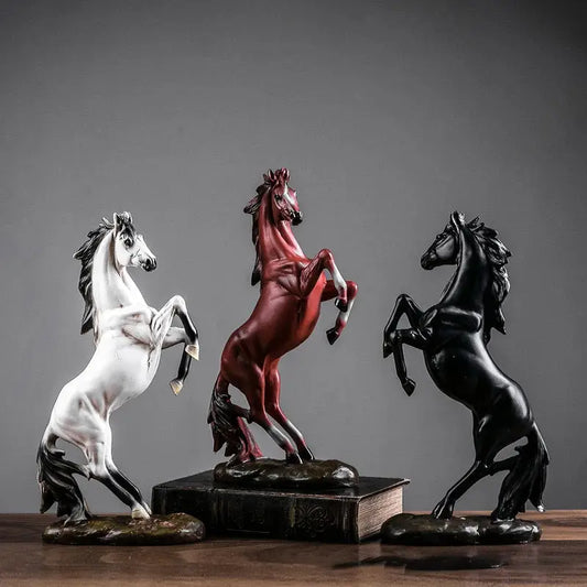 three horse figurines sitting on top of a book
