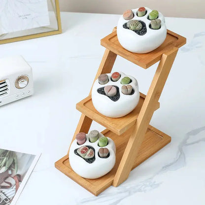 a couple of white bowls sitting on top of a wooden stand