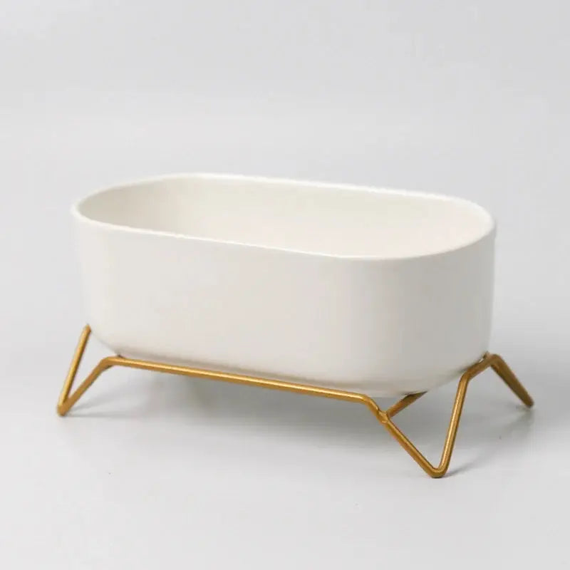 a white bowl sitting on top of a metal stand