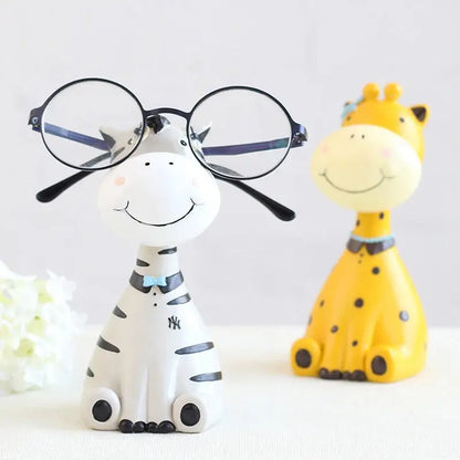 a ceramic giraffe and a ceramic giraffe wearing glasses