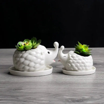 a couple of white ceramic animals with plants in them