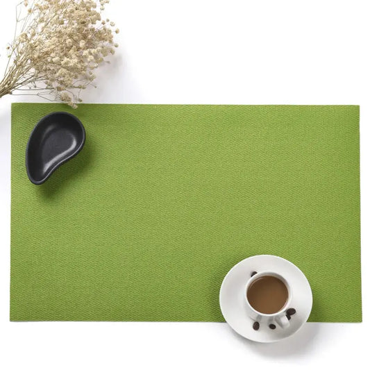a cup of coffee on a green place mat