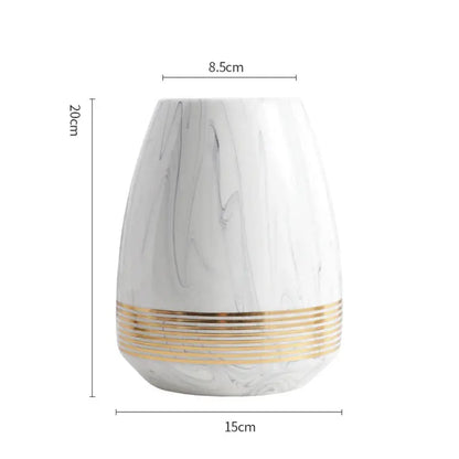 a white vase with gold stripes on it